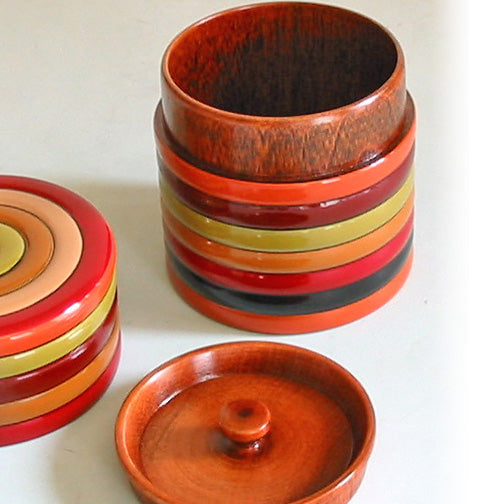 Small wooden tea caddy with spinning top design, lacquered
