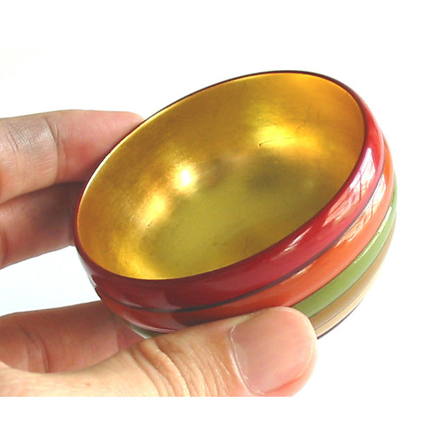 Sake cup with spinning top design and gold leaf on the inside, made of wood and lacquered