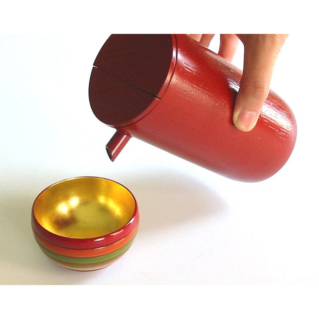 Sake cup with spinning top design and gold leaf on the inside, made of wood and lacquered