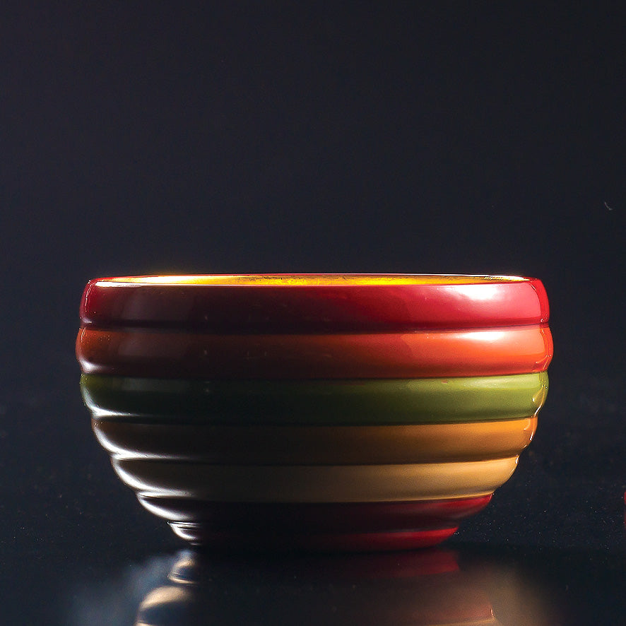 Sake cup with spinning top design and gold leaf on the inside, made of wood and lacquered